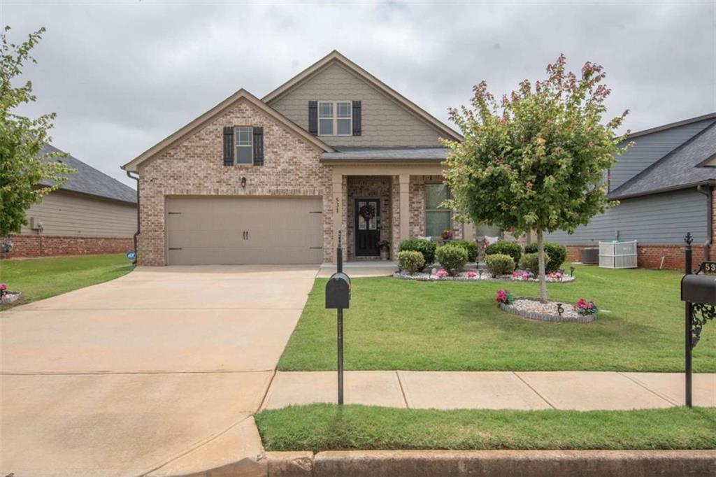 531 Carleton Place Locust Grove, GA 30248 - Photo 1 of 41 a front view of a house with a yard