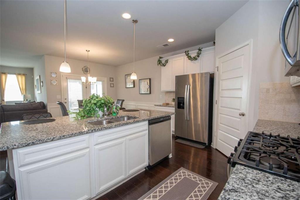 531 Carleton Place Locust Grove, GA 30248 - Photo 13 of 41 a kitchen with a sink stainless steel appliances and cabinets