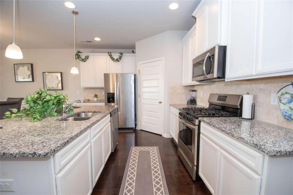 531 Carleton Place Locust Grove, GA 30248 - Photo 15 of 41 a kitchen with stainless steel appliances granite countertop a sink stove and refrigerator