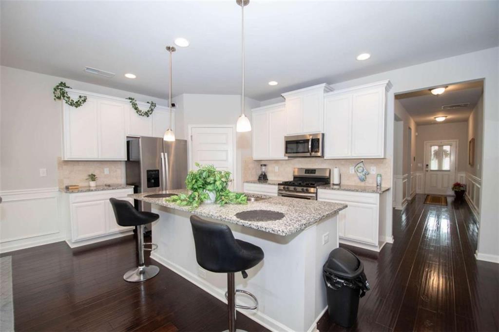 531 Carleton Place Locust Grove, GA 30248 - Photo 16 of 41 a kitchen with sink refrigerator and microwave