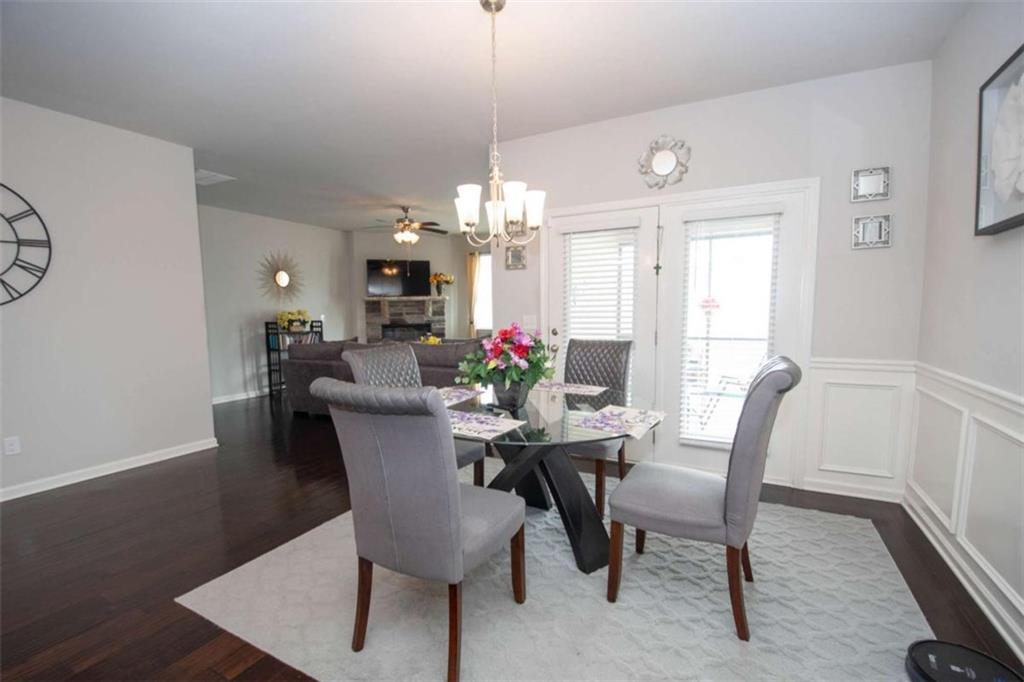 531 Carleton Place Locust Grove, GA 30248 - Photo 19 of 41 a dining room with furniture potted plants and wooden floor