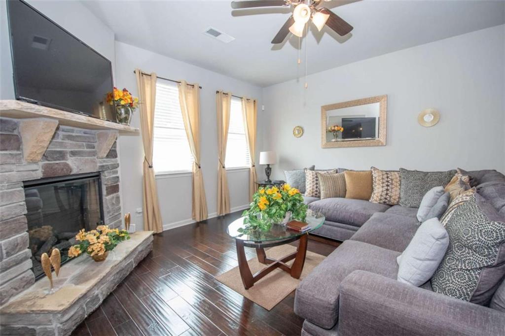 531 Carleton Place Locust Grove, GA 30248 - Photo 21 of 41 a living room with furniture flowerpot and a fireplace