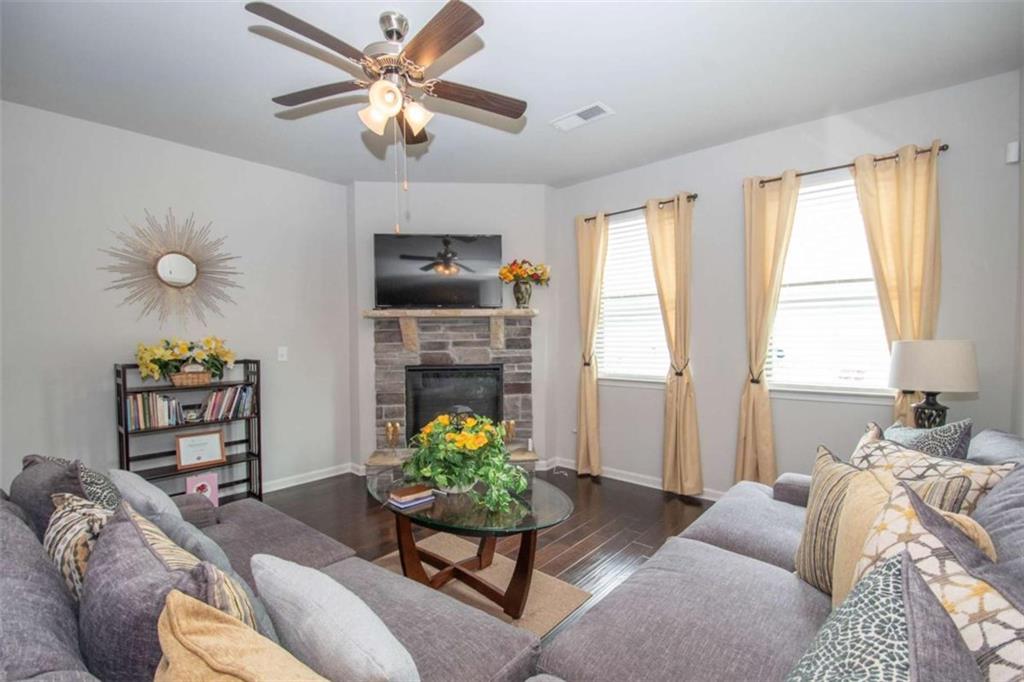 531 Carleton Place Locust Grove, GA 30248 - Photo 22 of 41 a living room with furniture a chandelier and a window