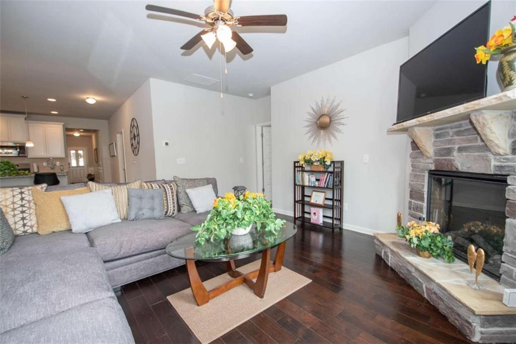 531 Carleton Place Locust Grove, GA 30248 - Photo 24 of 41 a living room with furniture and a wooden floor