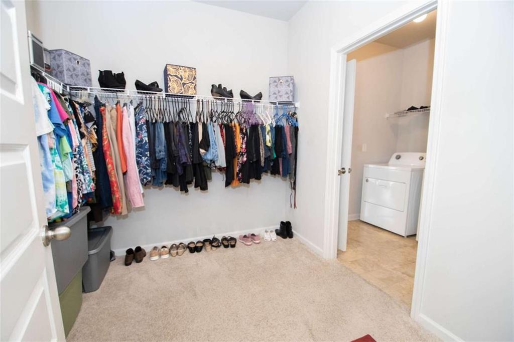531 Carleton Place Locust Grove, GA 30248 - Photo 30 of 41 a view of walk in closet with clothes and shoes