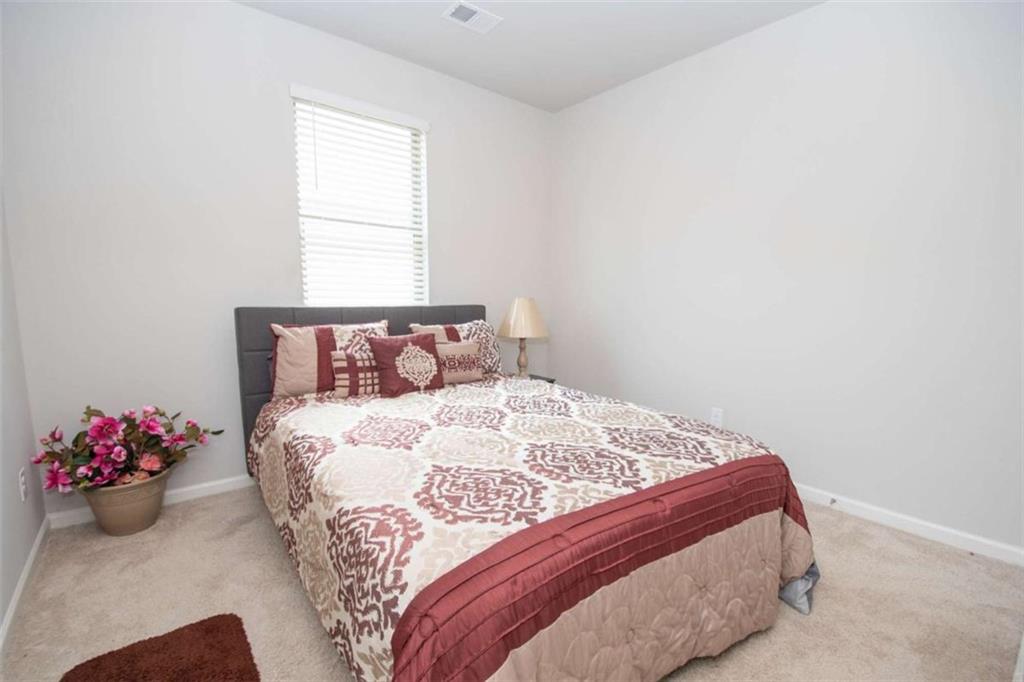 531 Carleton Place Locust Grove, GA 30248 - Photo 31 of 41 a bedroom with a bed and a window