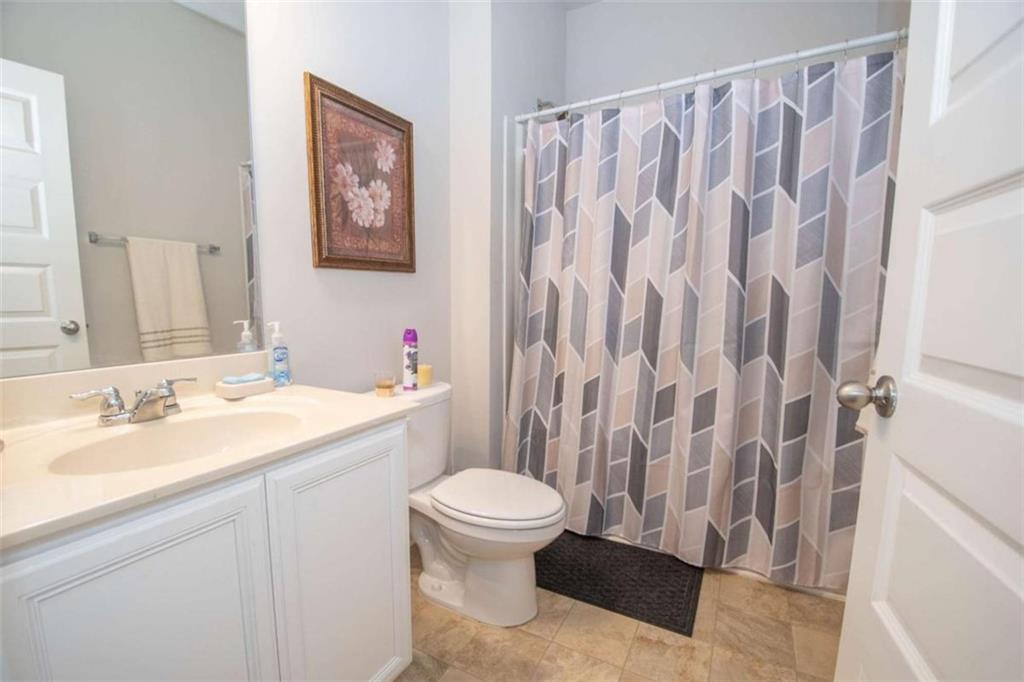 531 Carleton Place Locust Grove, GA 30248 - Photo 35 of 41 a bathroom with a sink and a mirror