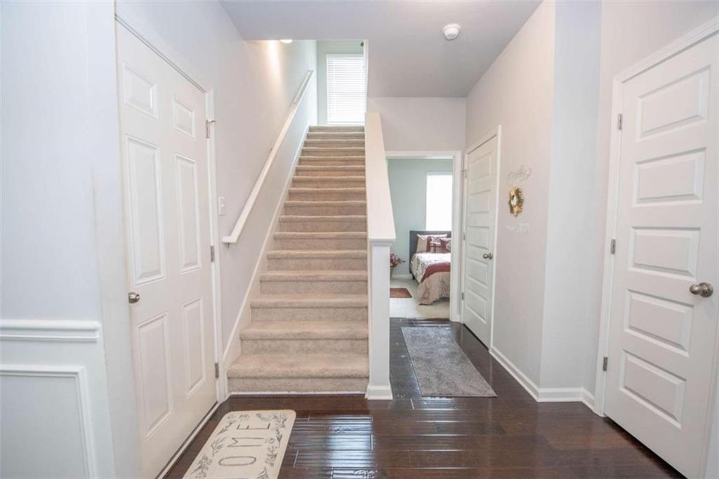 531 Carleton Place Locust Grove, GA 30248 - Photo 36 of 41 a view of a hallway with wooden floor and entryway
