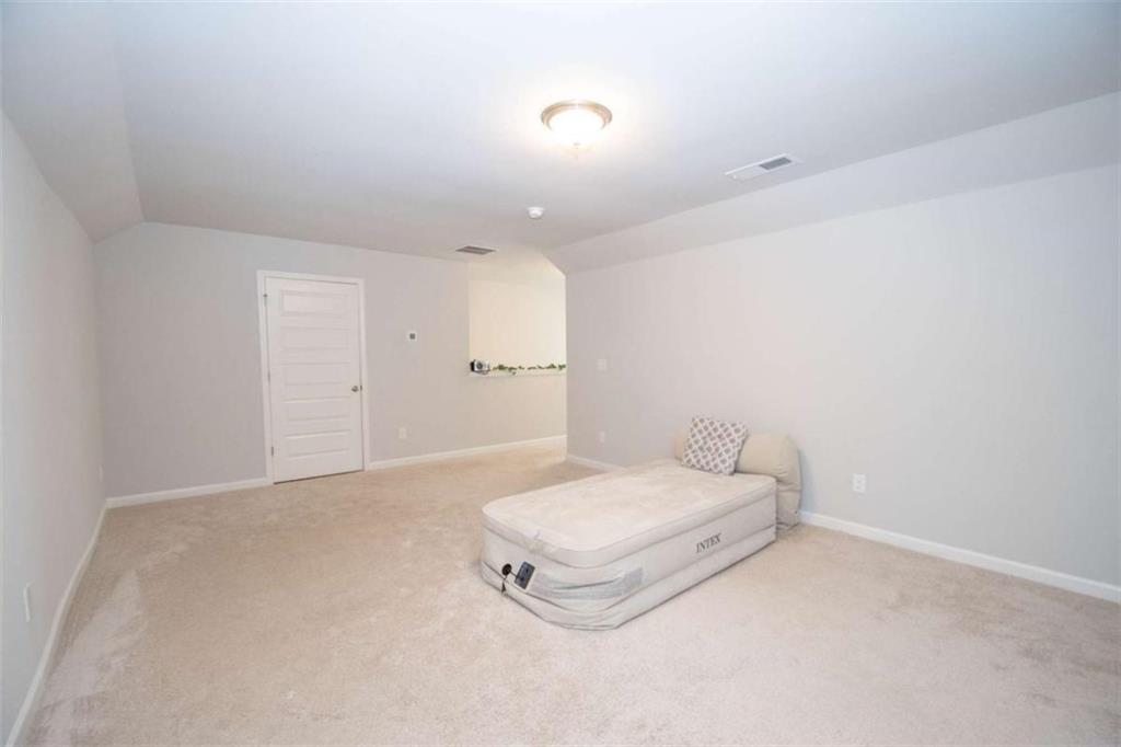 531 Carleton Place Locust Grove, GA 30248 - Photo 37 of 41 a room with a bed and a night stand