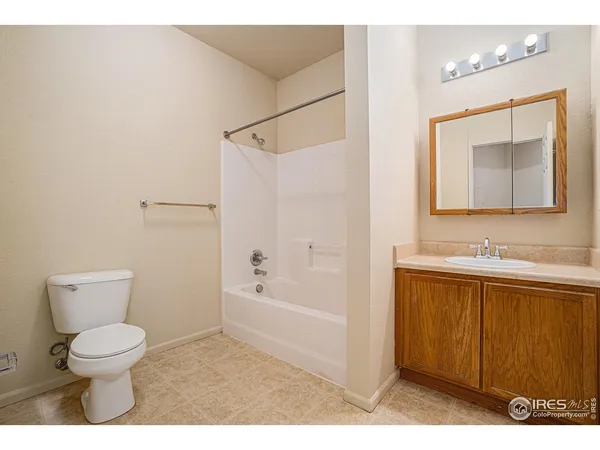 a bathroom with a toilet a sink a mirror and bathtub