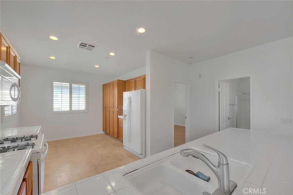 8150 West Preserve Loop Chino, CA 91708 - Photo 18 of 51 a bedroom with a bed and a stove top oven
