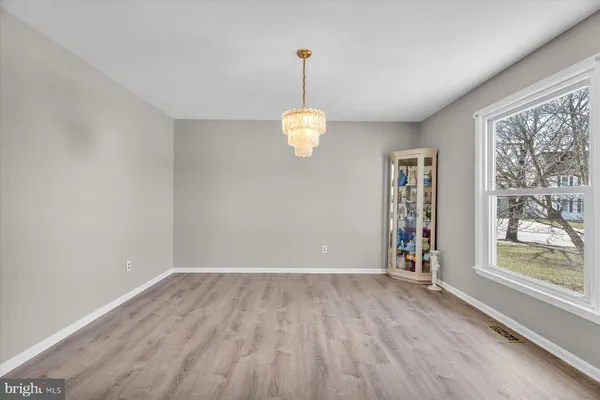 a view of a room with wooden floor windows and chandelier