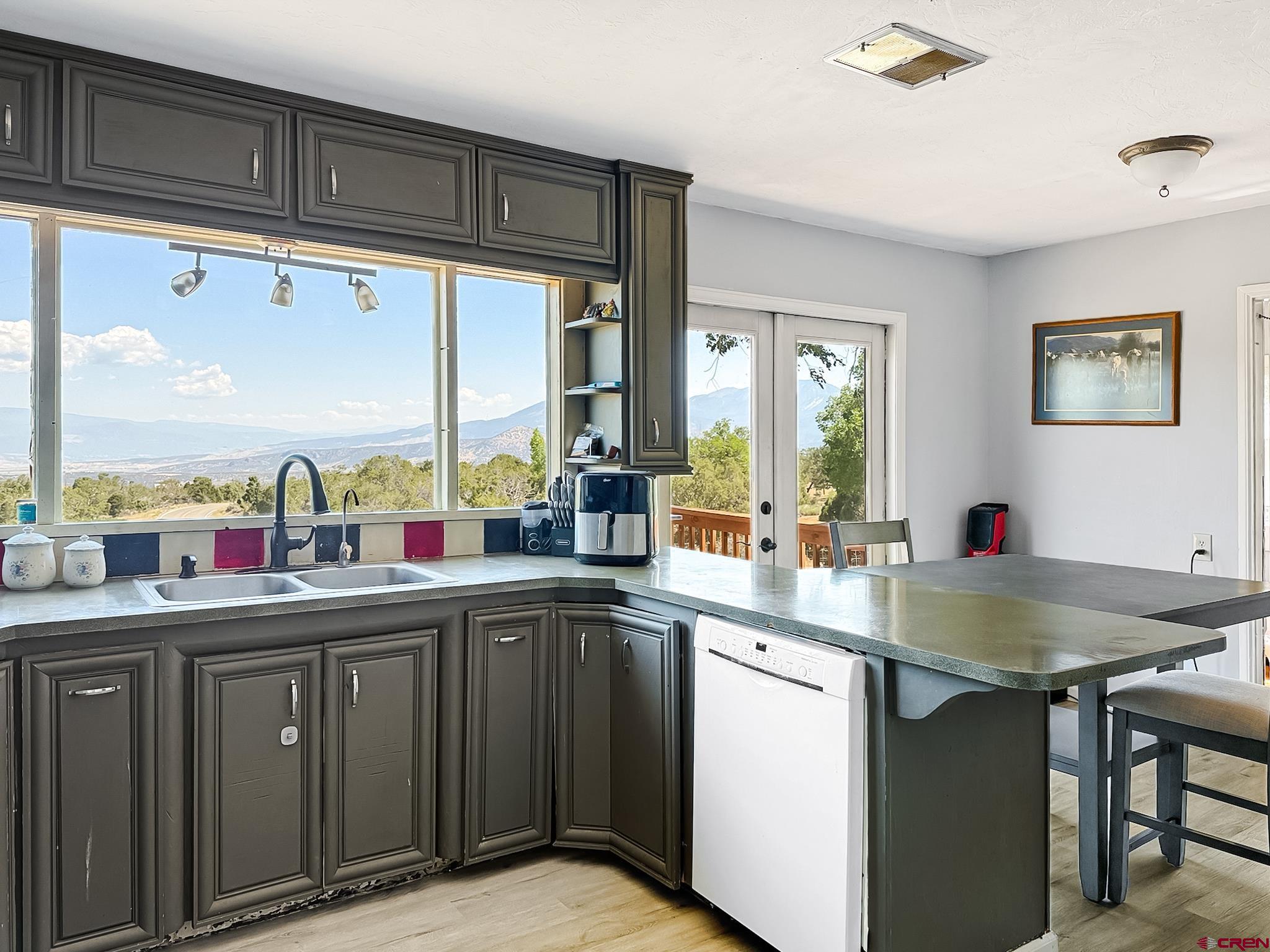2001 Black Canyon Road Crawford, CO 81415 - Photo 11 of 45 a kitchen with stainless steel appliances a sink stove and cabinets