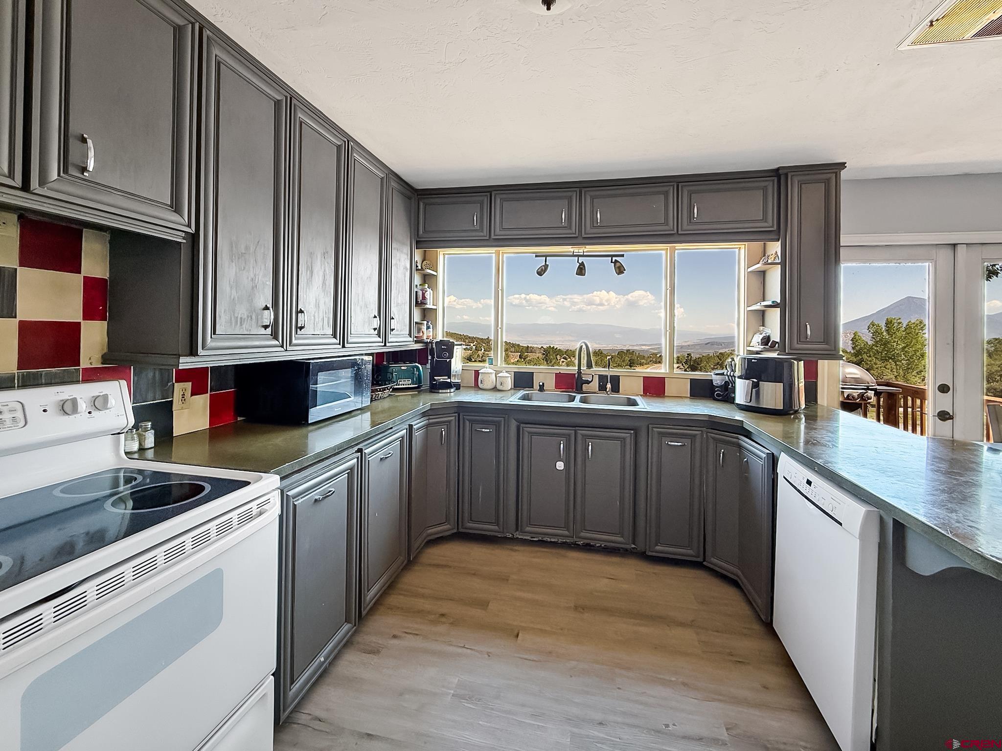 2001 Black Canyon Road Crawford, CO 81415 - Photo 12 of 45 a kitchen with stainless steel appliances a sink window and cabinets