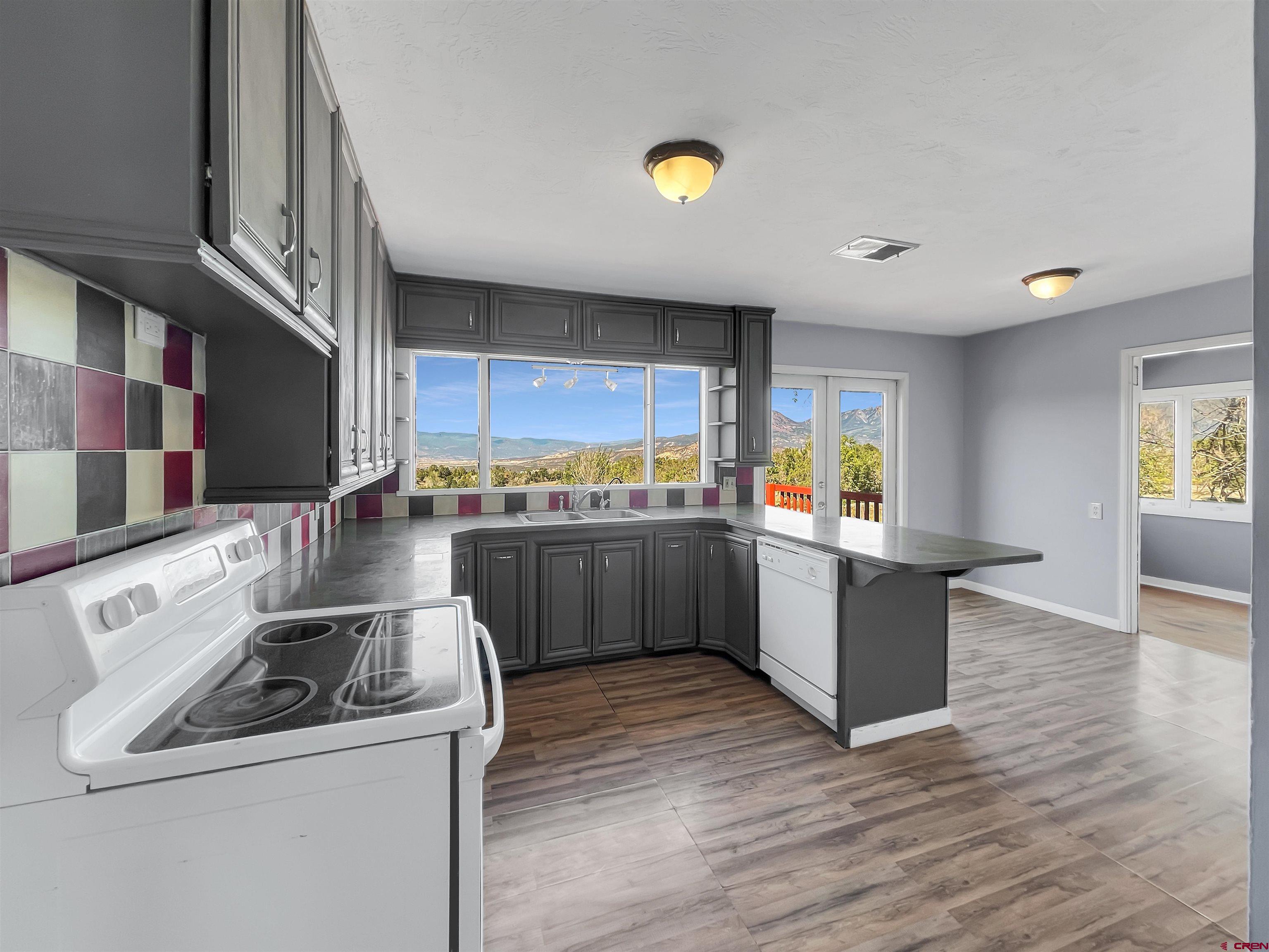 2001 Black Canyon Road Crawford, CO 81415 - Photo 14 of 45 a kitchen with a sink and wooden cabinets