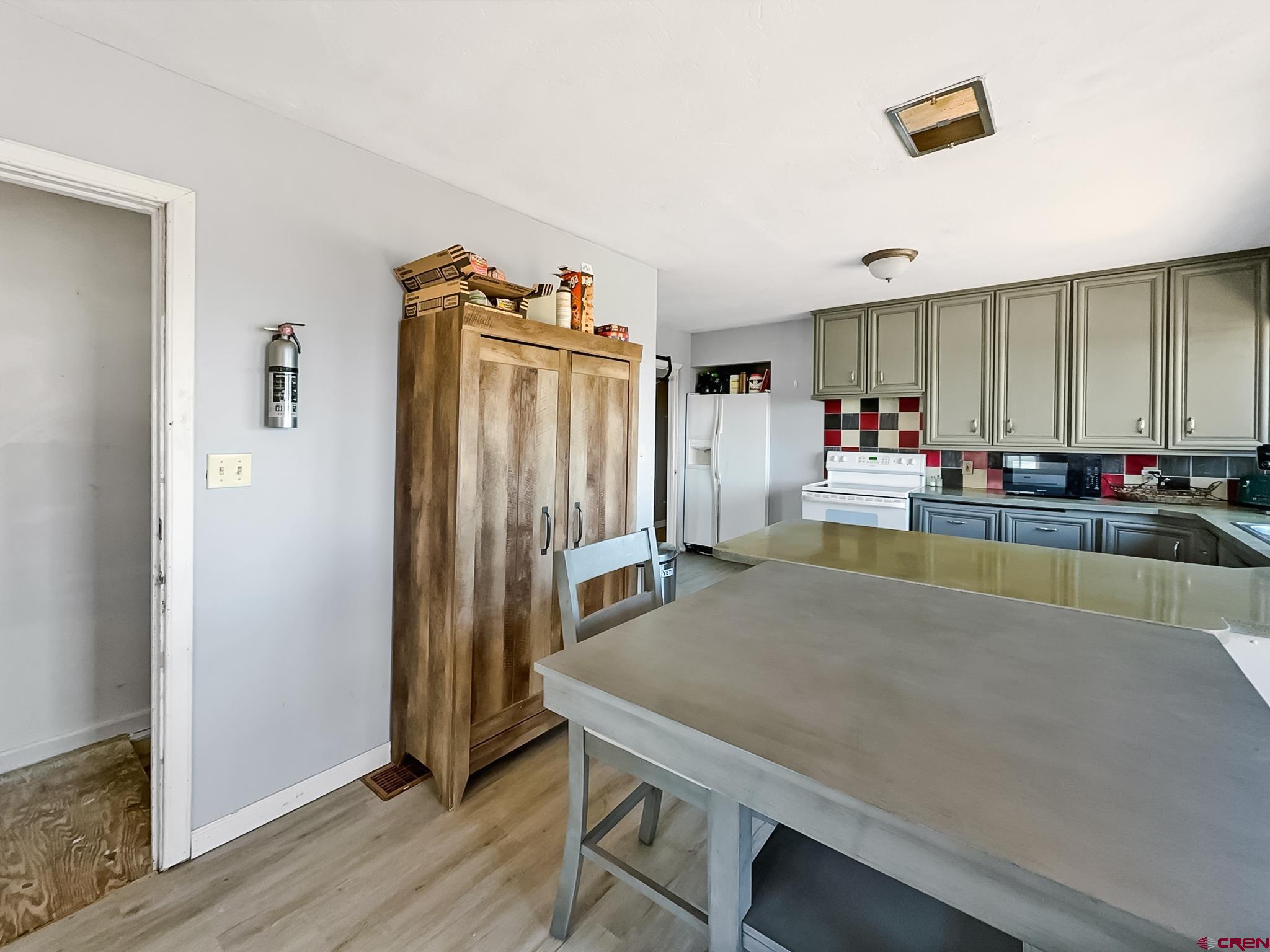2001 Black Canyon Road Crawford, CO 81415 - Photo 16 of 45 a kitchen with stainless steel appliances granite countertop a refrigerator and a stove top oven
