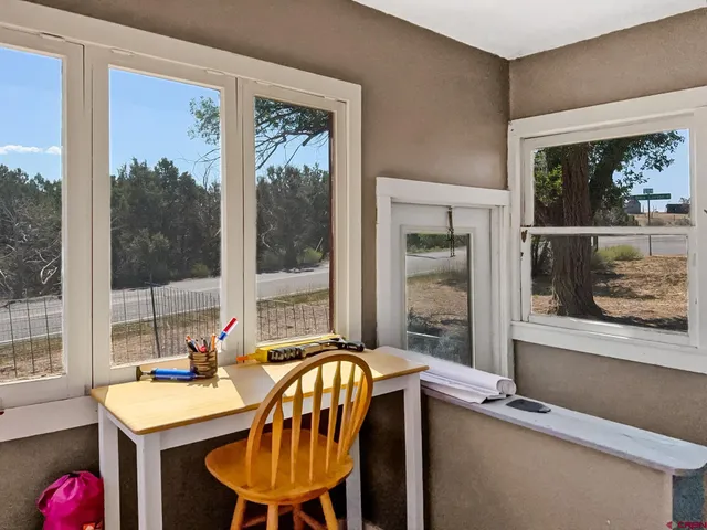a dining room with furniture a chandelier and window