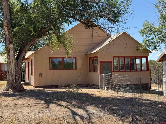 a house with trees in the background