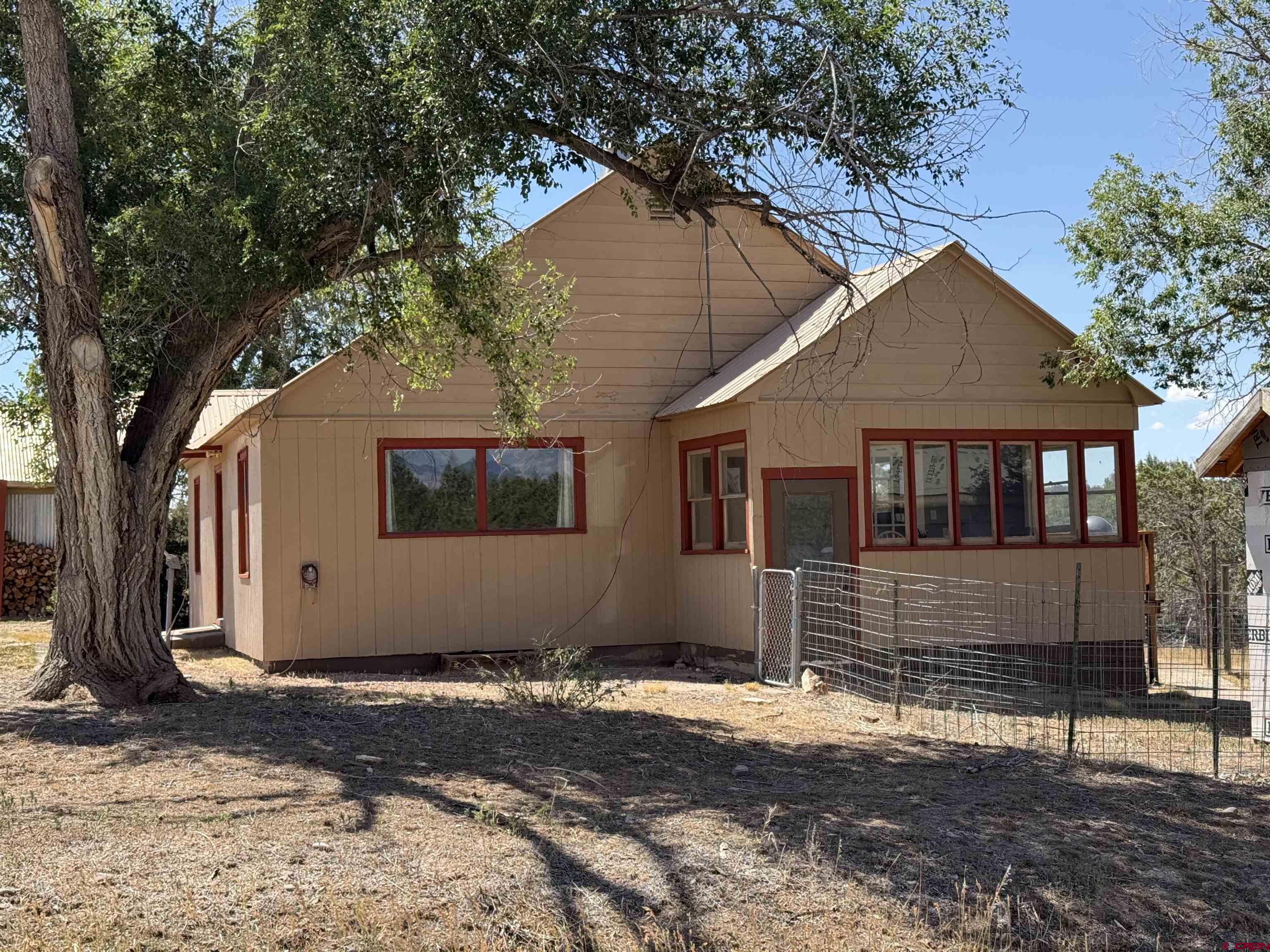 2001 Black Canyon Road Crawford, CO 81415 - Photo 2 of 45 a house with trees in the background