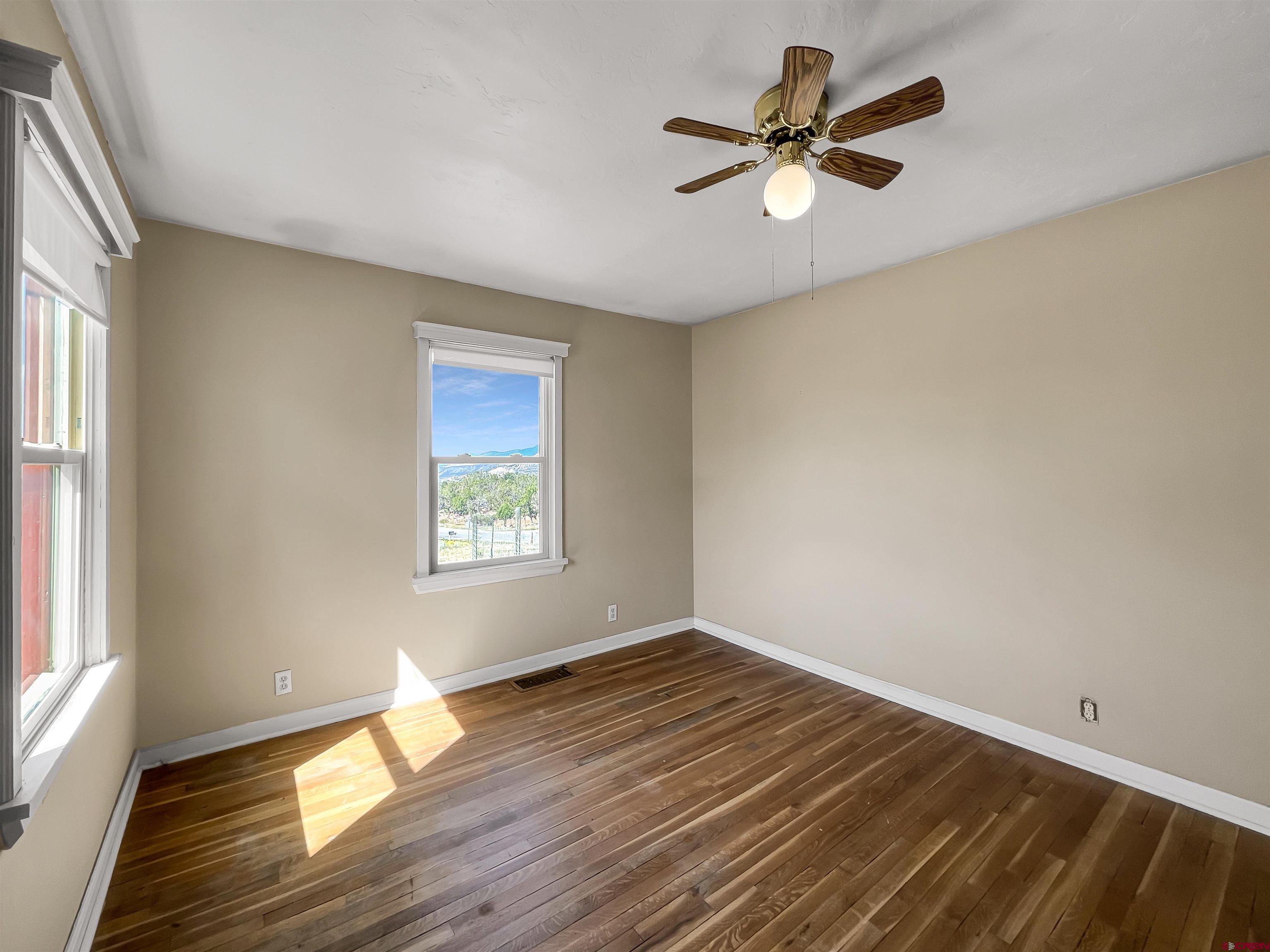 2001 Black Canyon Road Crawford, CO 81415 - Photo 21 of 45 an empty room with wooden floor and windows
