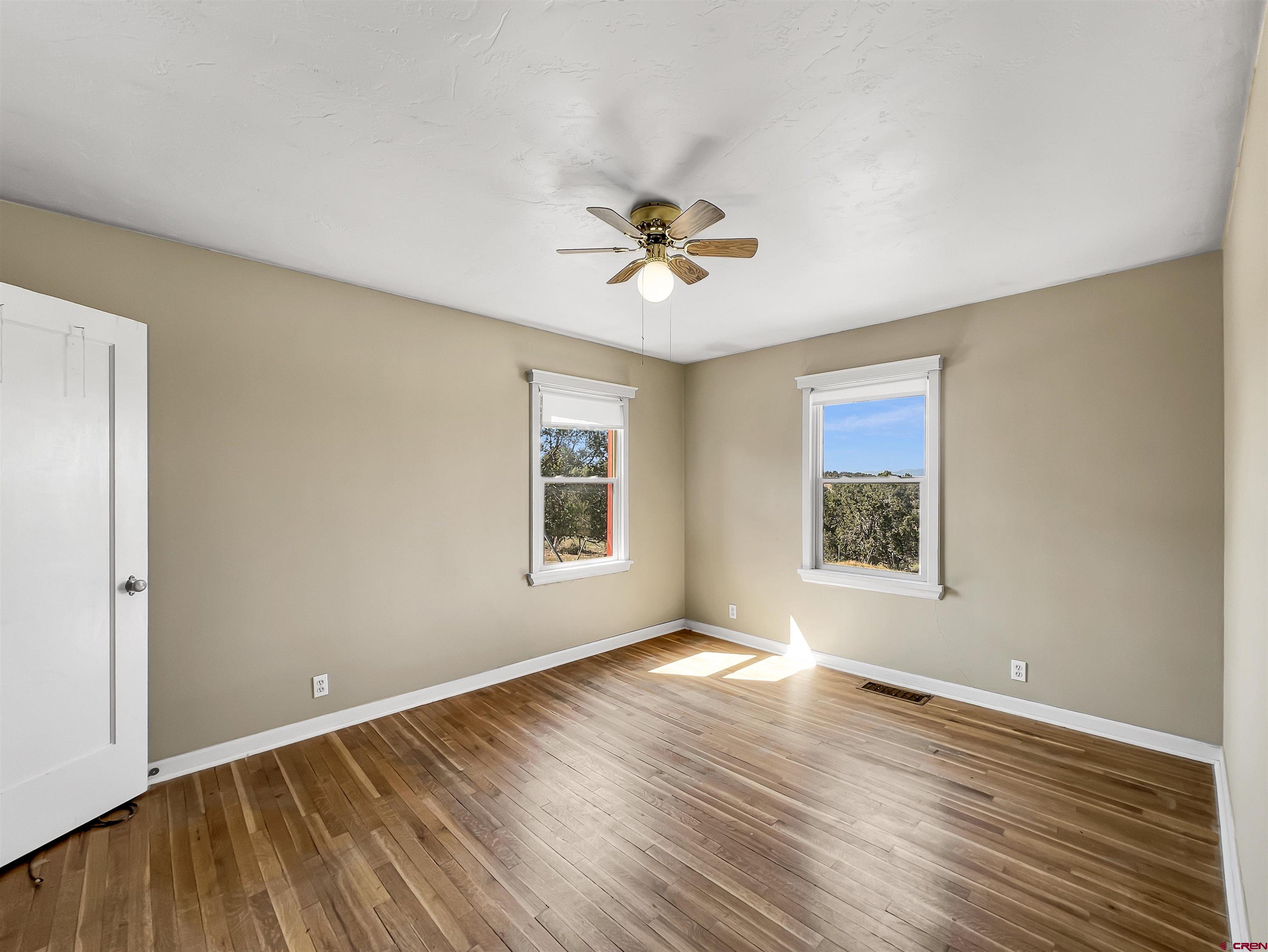2001 Black Canyon Road Crawford, CO 81415 - Photo 22 of 45 a view of an empty room with a window and wooden floor