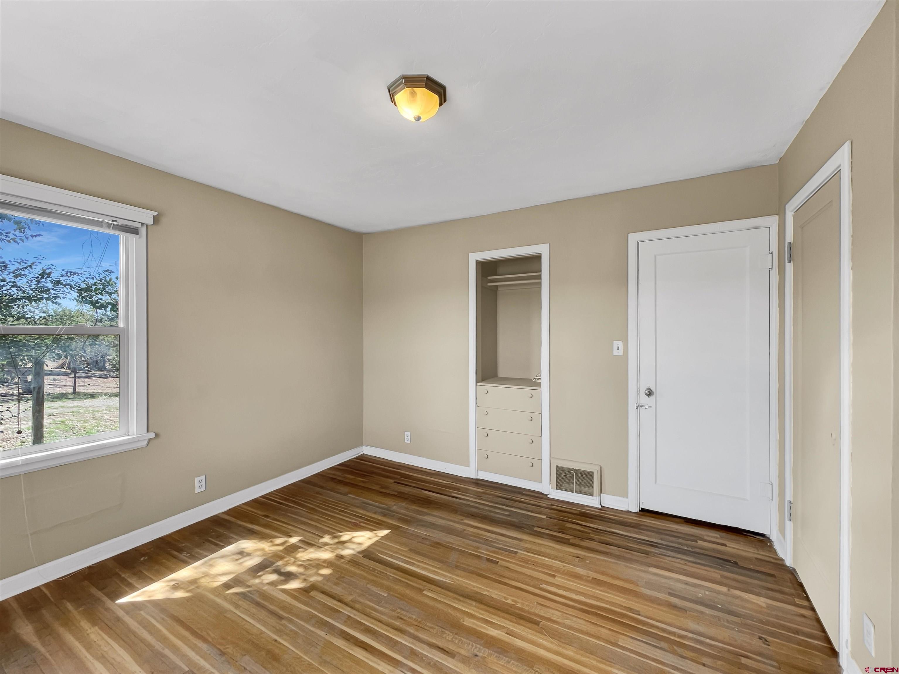 2001 Black Canyon Road Crawford, CO 81415 - Photo 23 of 45 a view of empty room with wooden floor and fan