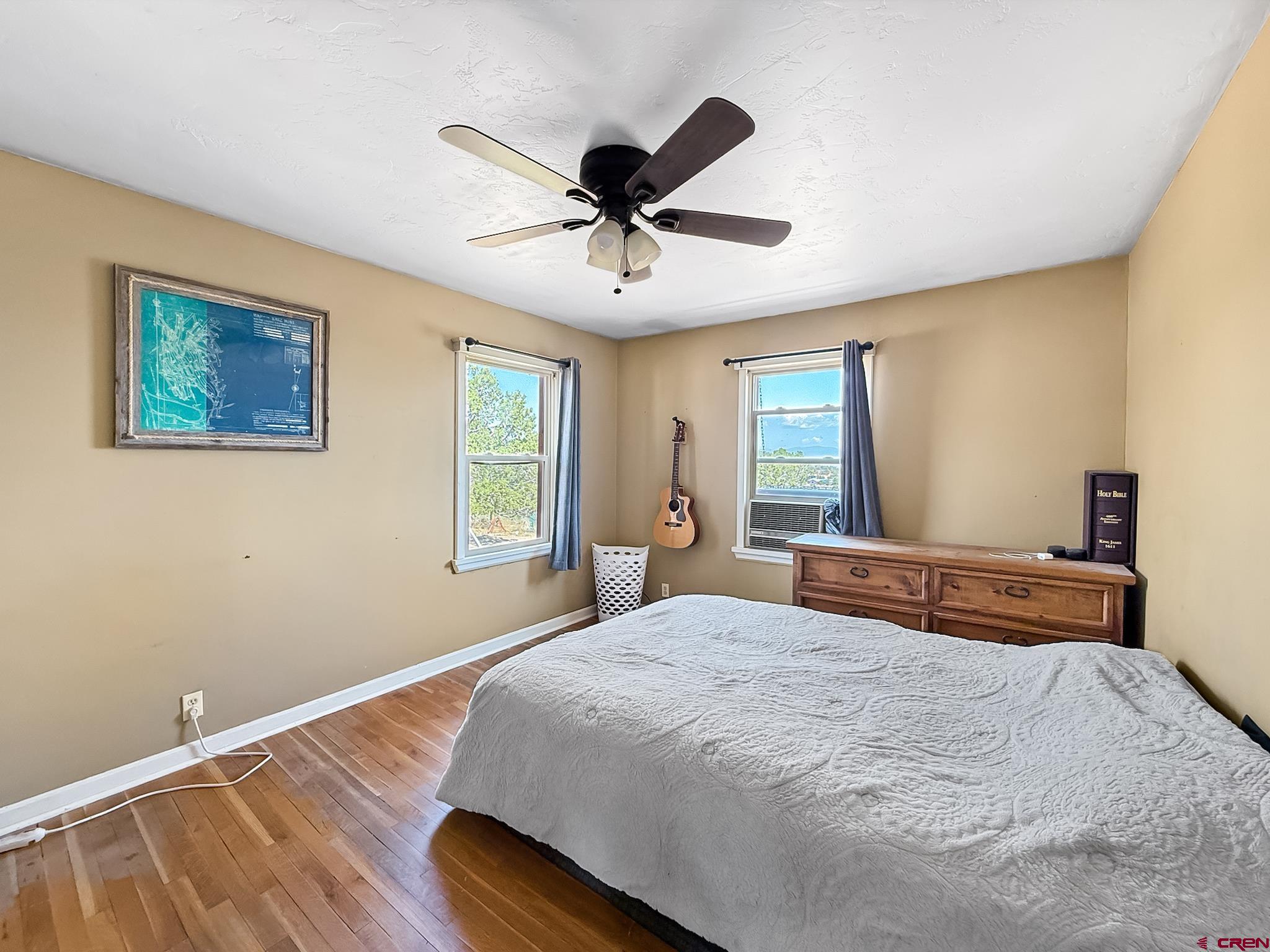2001 Black Canyon Road Crawford, CO 81415 - Photo 28 of 45 a bedroom with a bed and a chandelier