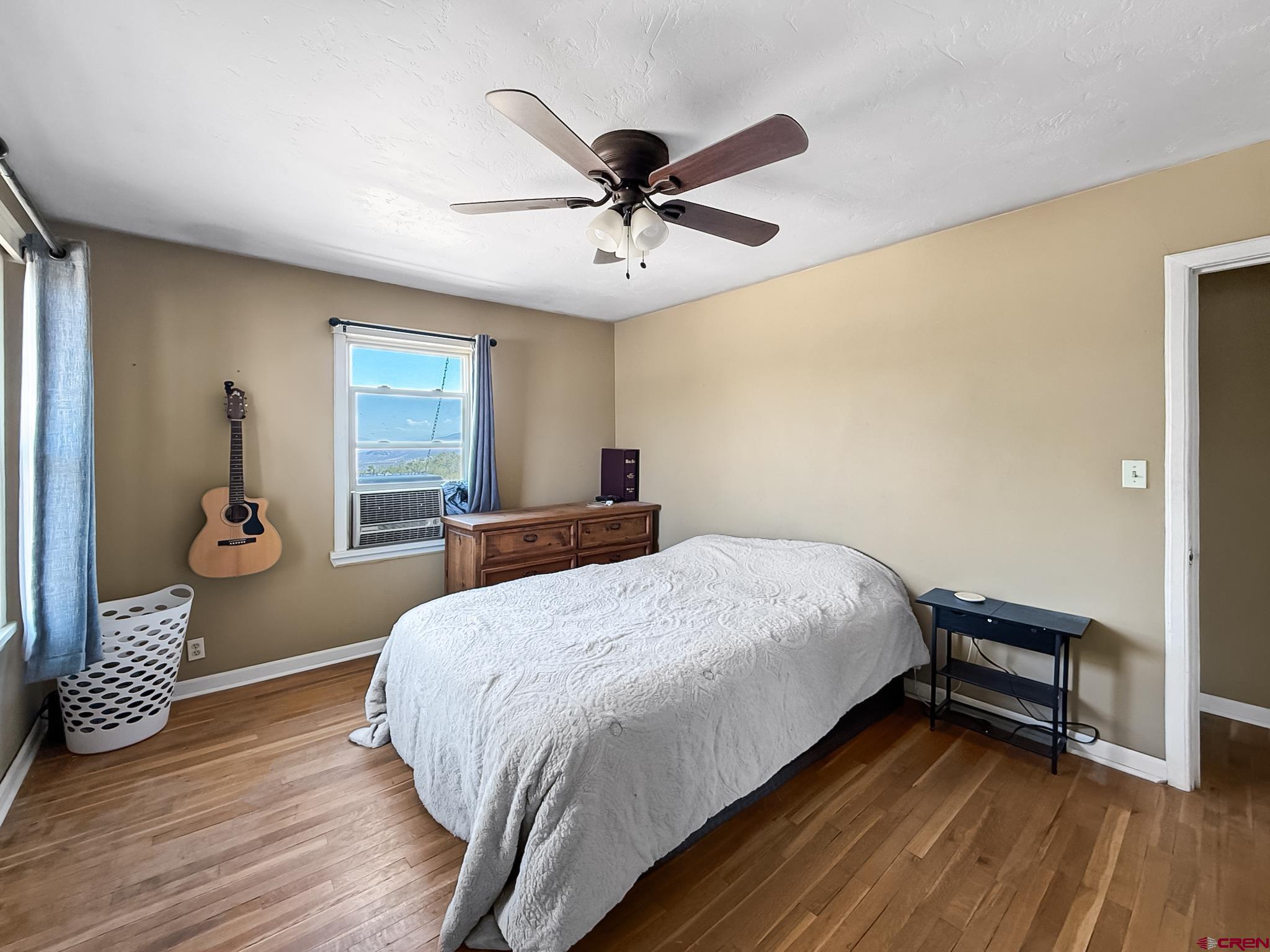 2001 Black Canyon Road Crawford, CO 81415 - Photo 29 of 45 a bedroom with a bed and a chandelier