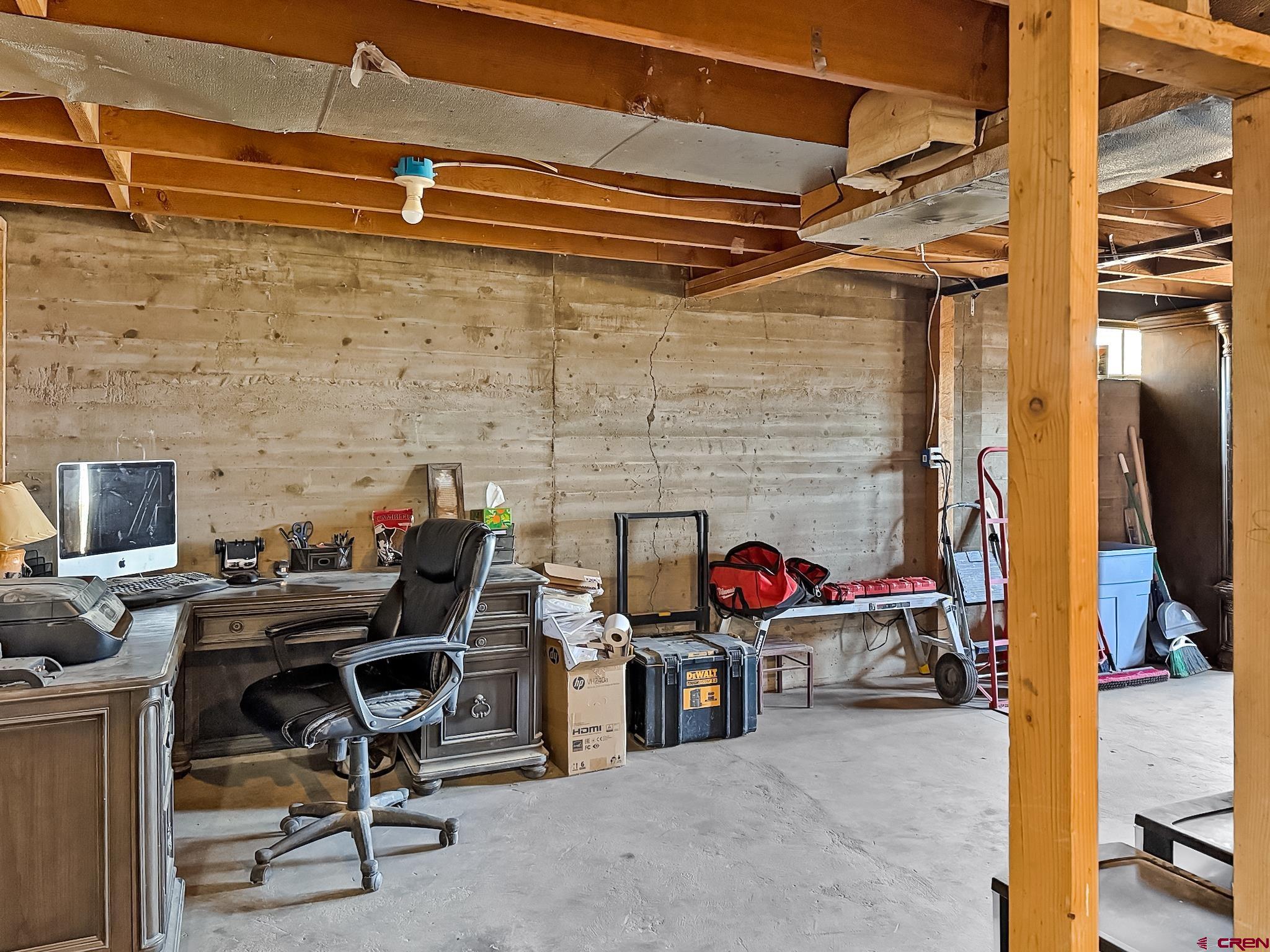 2001 Black Canyon Road Crawford, CO 81415 - Photo 37 of 45 a work room with furniture and a fireplace