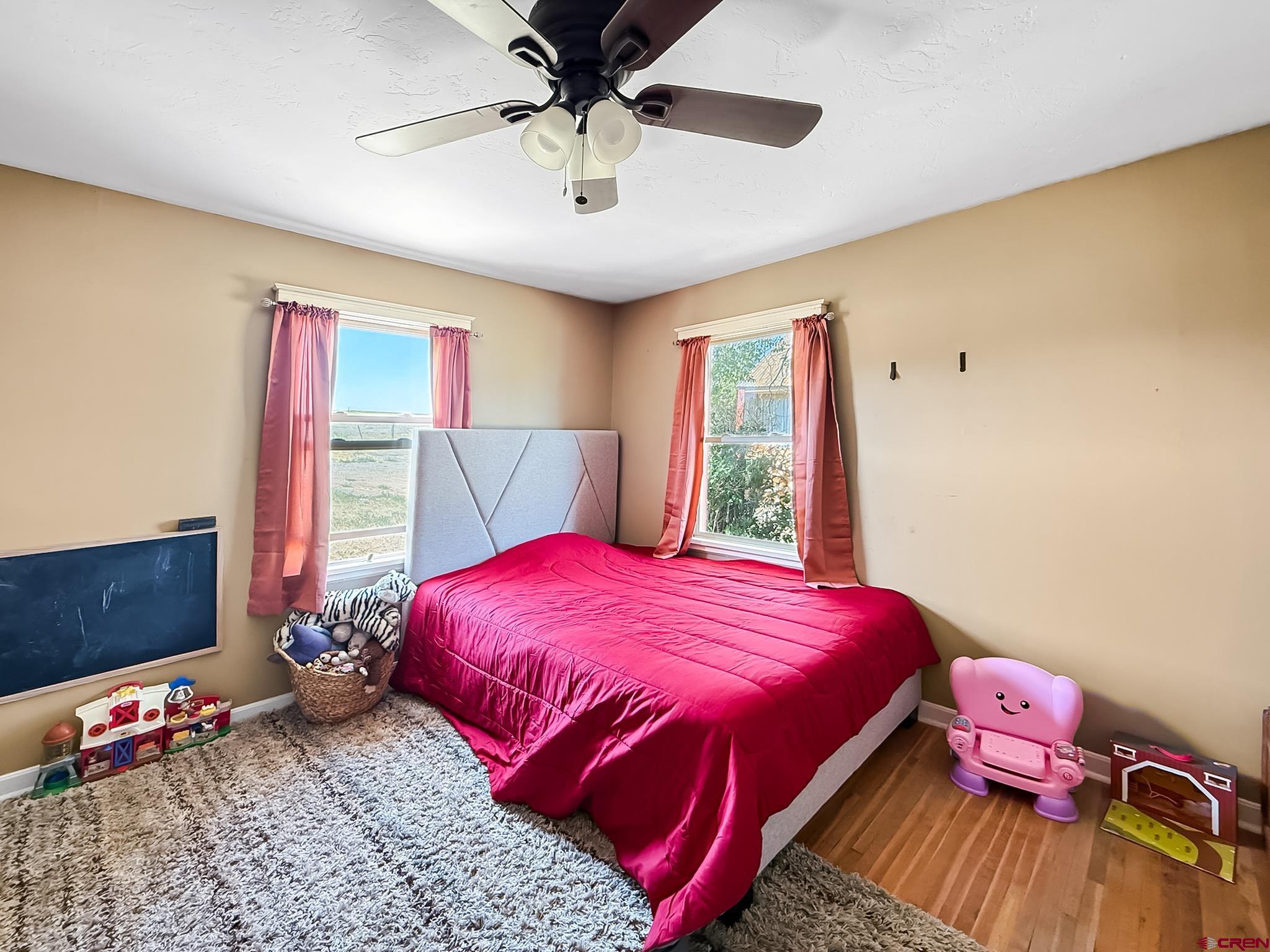 2001 Black Canyon Road Crawford, CO 81415 - Photo 40 of 45 a bedroom with a bed and wooden floor