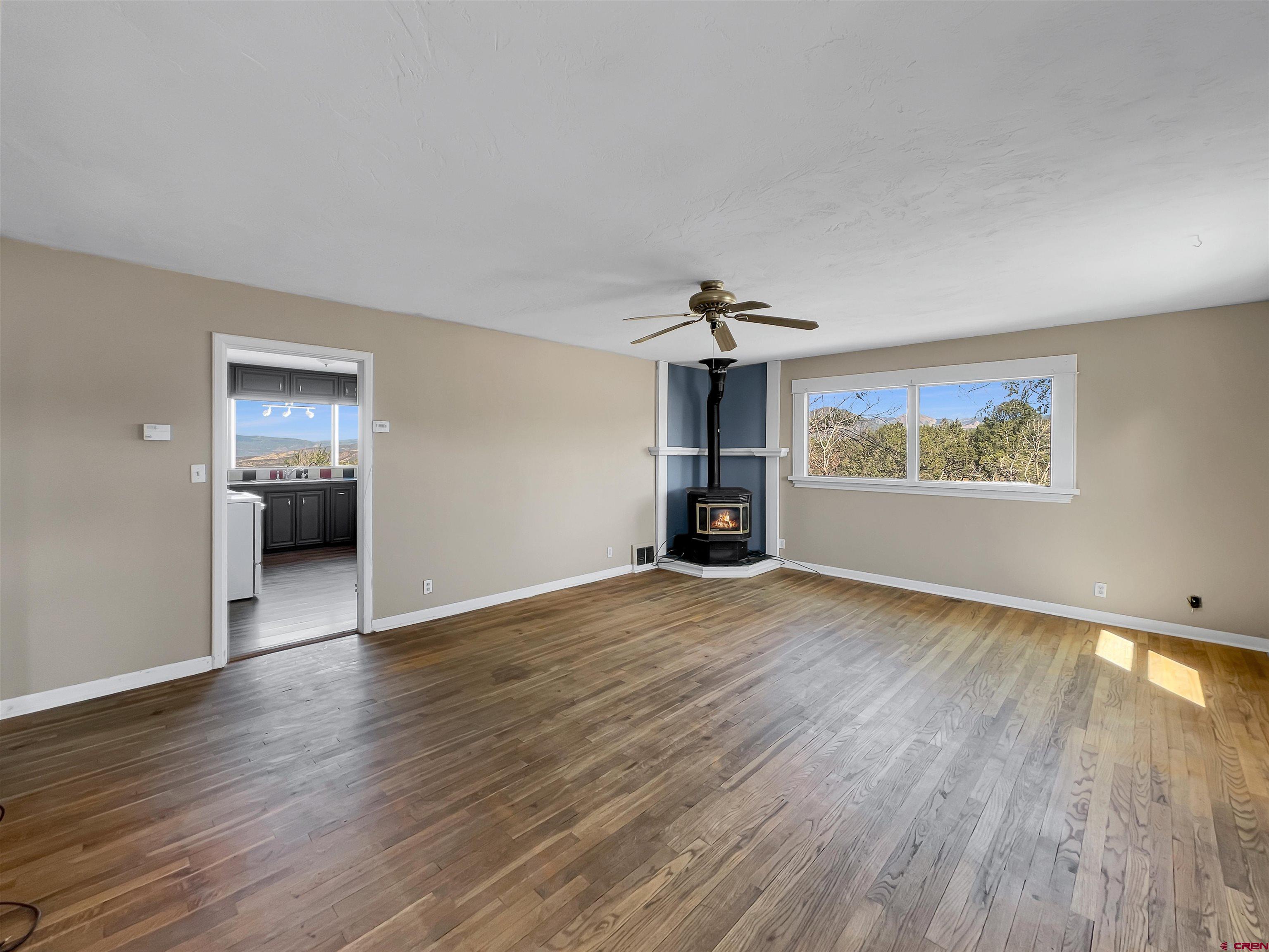 2001 Black Canyon Road Crawford, CO 81415 - Photo 4 of 45 a view of empty room with wooden floor and window