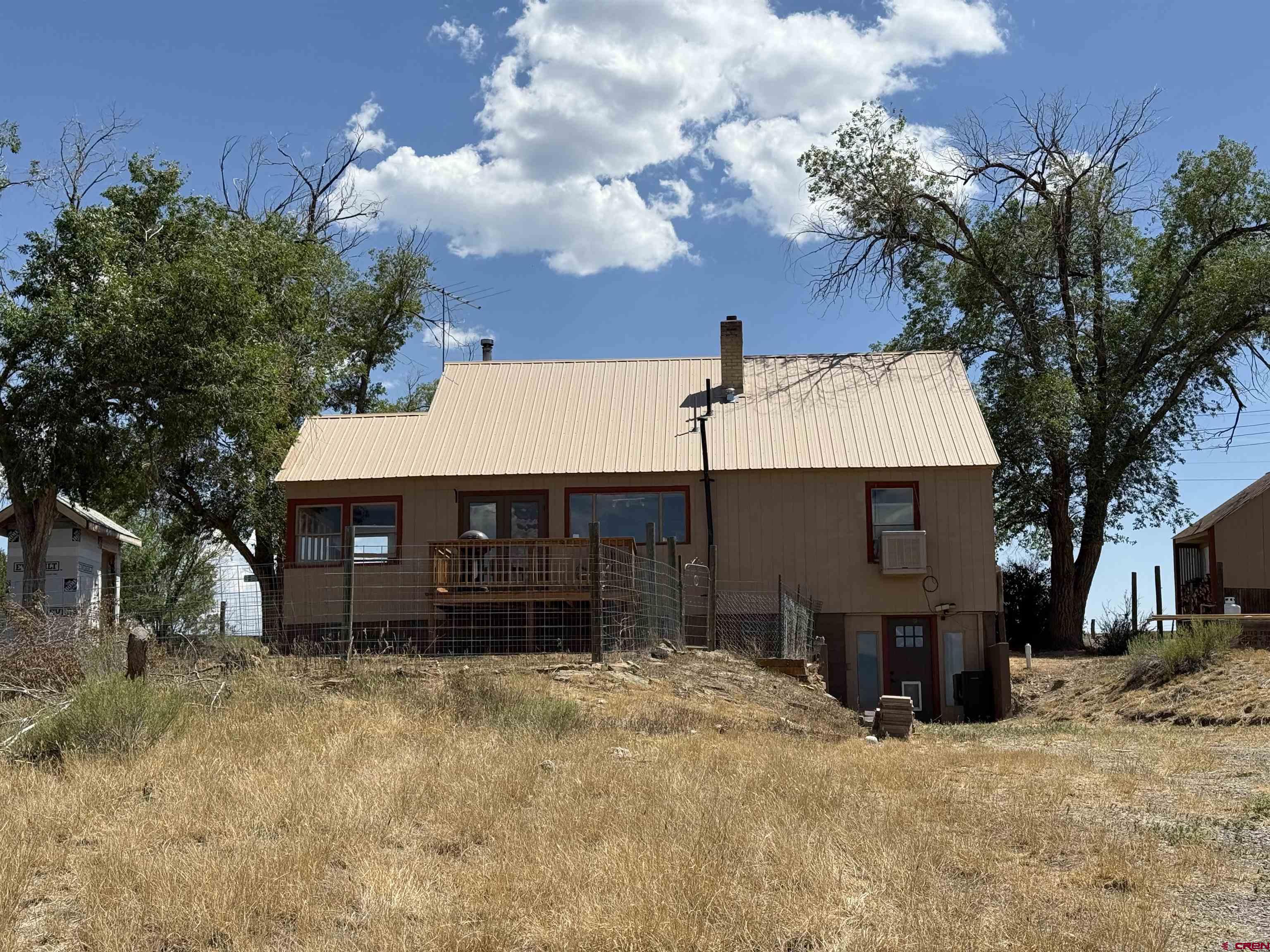 2001 Black Canyon Road Crawford, CO 81415 - Photo 41 of 45 a front view of a house with a yard and garage