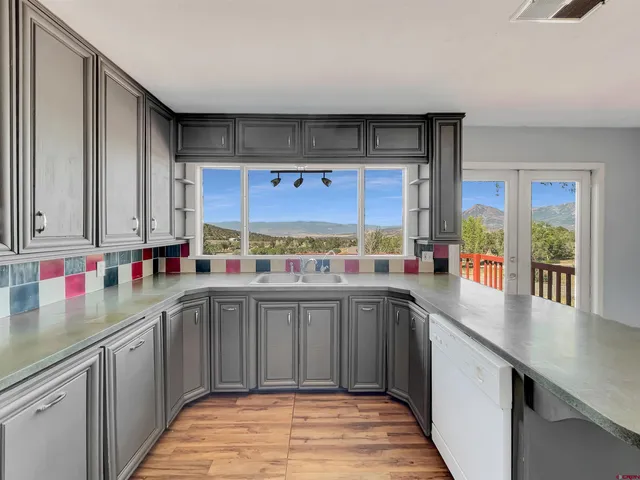a kitchen with stainless steel appliances a sink and cabinets