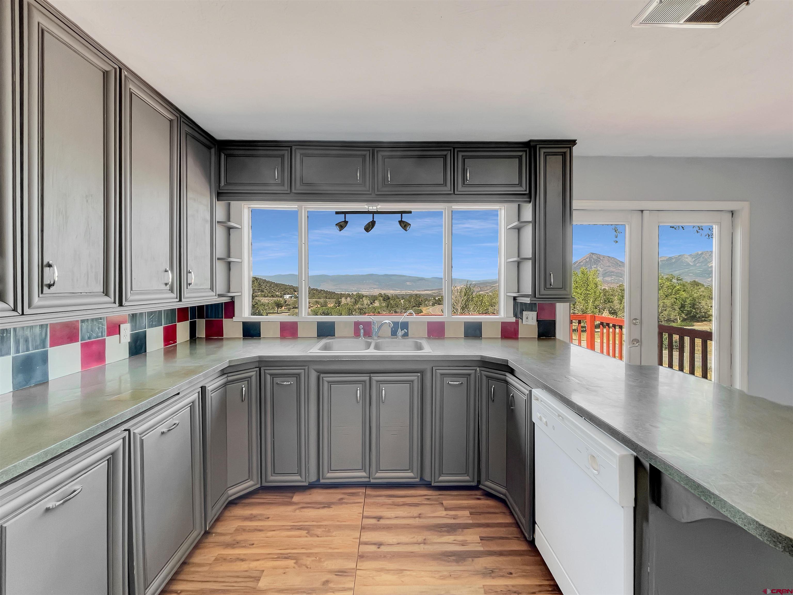 2001 Black Canyon Road Crawford, CO 81415 - Photo 10 of 45 a kitchen with stainless steel appliances a sink and cabinets