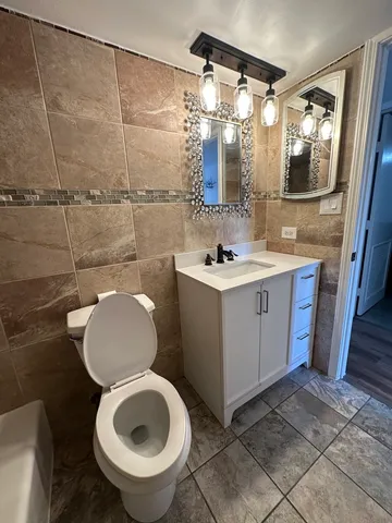 a bathroom with a sink a toilet and mirror