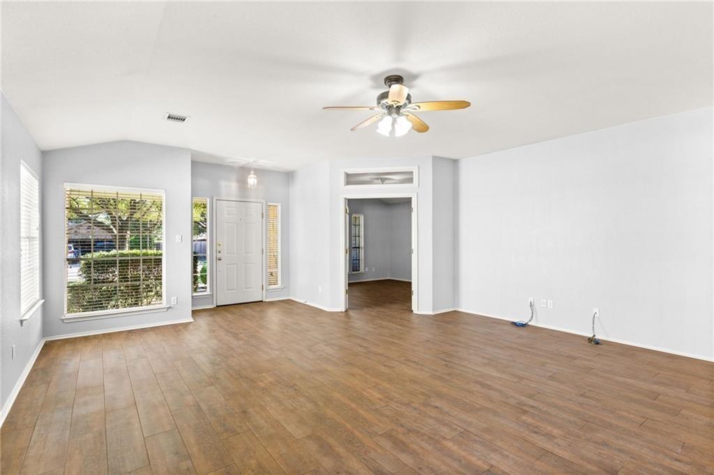 10708 Sycamore Hills Road Austin, TX 78717 - Photo 3 of 10 a view of an empty room with a window and wooden floor