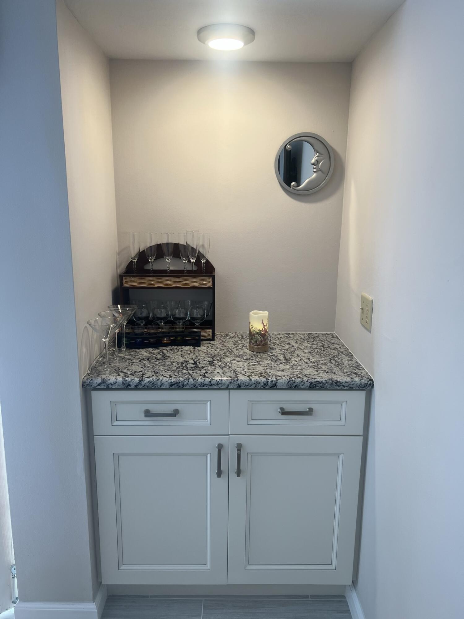 1605 Highway 1, Unit 201M2 Jupiter, FL 33477 - Photo 13 of 47 a bathroom with a granite countertop sink and a mirror