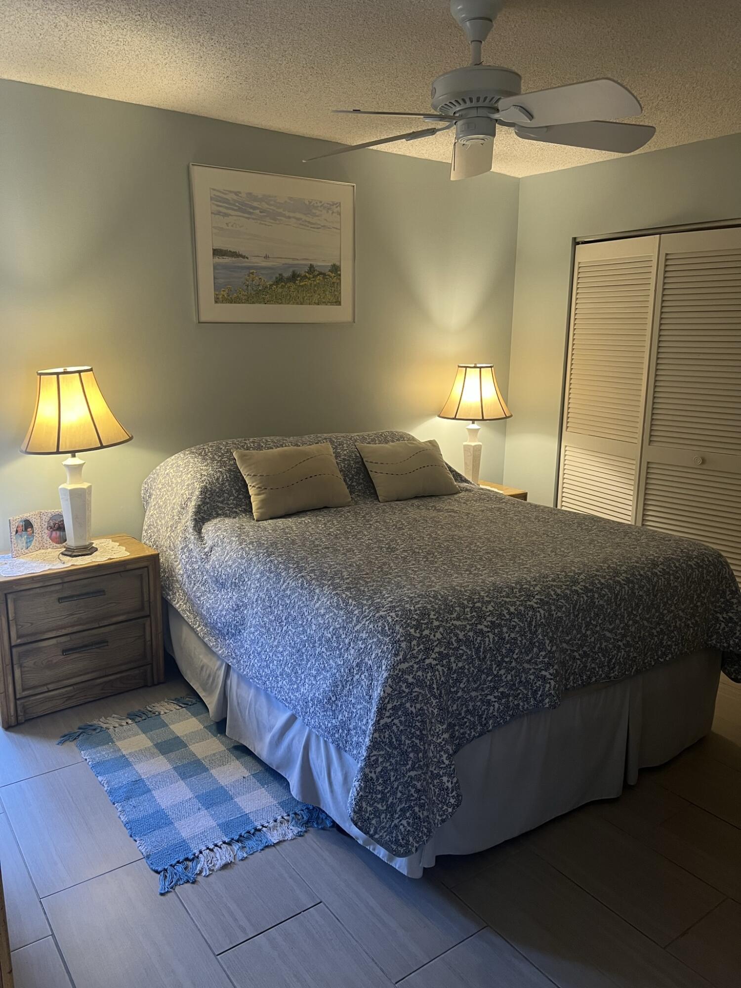 1605 Highway 1, Unit 201M2 Jupiter, FL 33477 - Photo 16 of 47 a bedroom with a bed and a chandelier