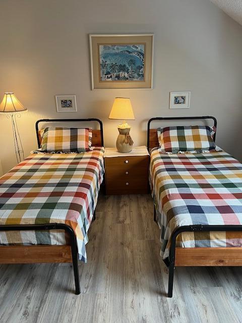 1605 Highway 1, Unit 201M2 Jupiter, FL 33477 - Photo 21 of 47 a bedroom with a bed and a night stand