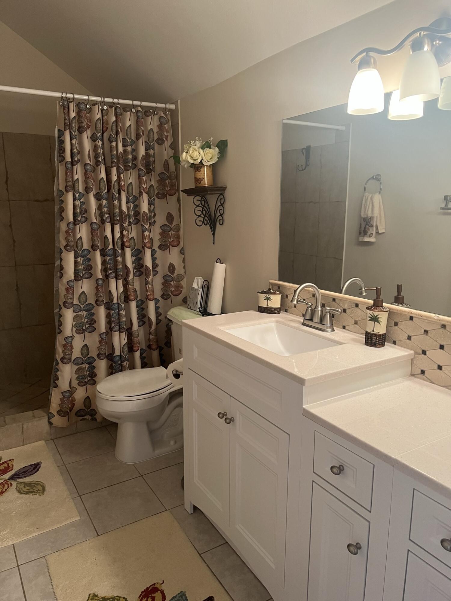 1605 Highway 1, Unit 201M2 Jupiter, FL 33477 - Photo 24 of 47 a bathroom with a sink toilet and shower