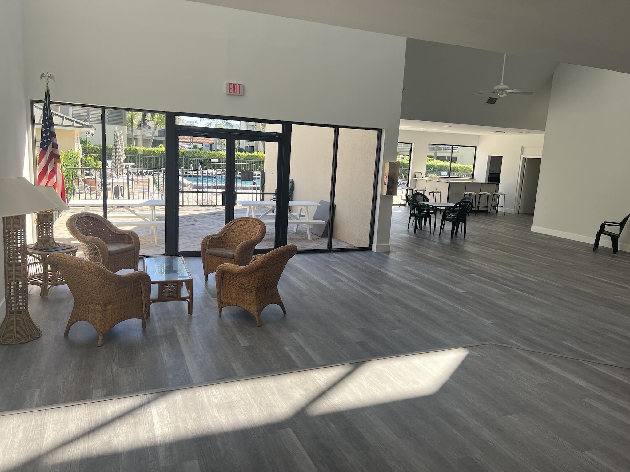 1605 Highway 1, Unit 201M2 Jupiter, FL 33477 - Photo 32 of 47 a living room with furniture and large windows