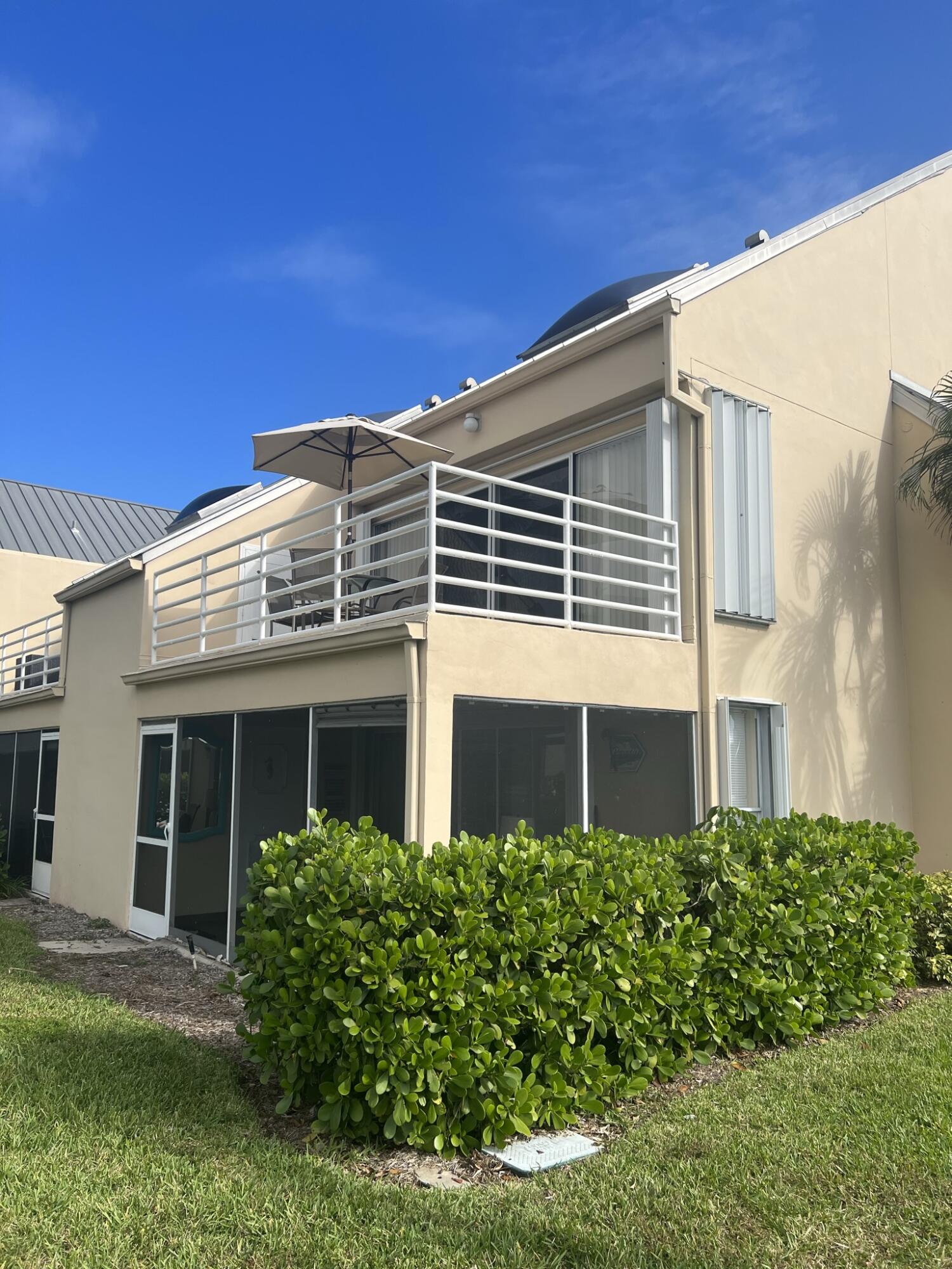 1605 Highway 1, Unit 201M2 Jupiter, FL 33477 - Photo 41 of 47 a front view of a house with a yard