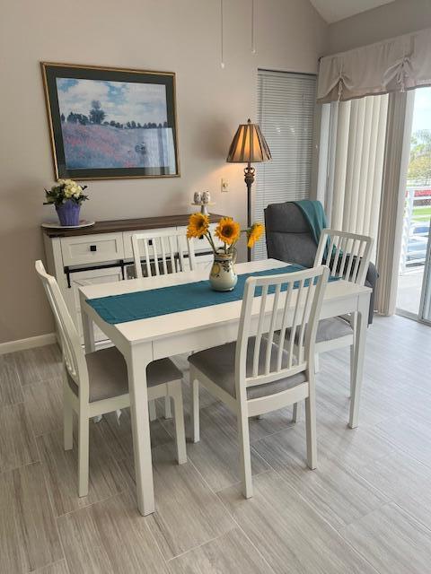 1605 Highway 1, Unit 201M2 Jupiter, FL 33477 - Photo 7 of 47 a view of a dining room with furniture and wooden floor