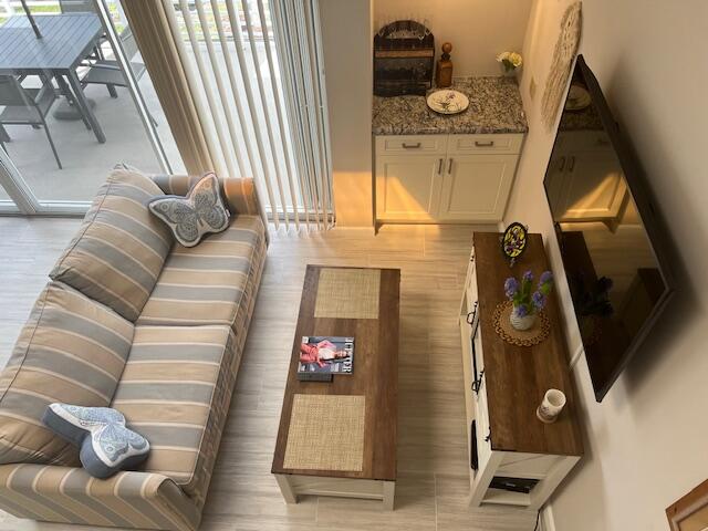 1605 Highway 1, Unit 201M2 Jupiter, FL 33477 - Photo 10 of 47 a living room with furniture and a window