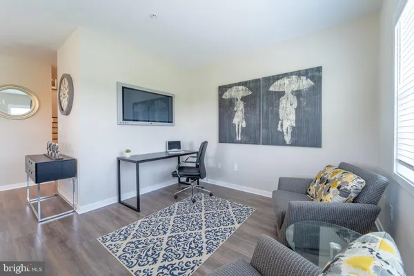 a living room with furniture a rug and a window