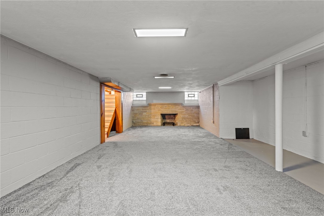 6315 Brookside Road Independence, OH 44131 - Photo 31 of 41 Below grade area with carpet floors, concrete block wall, and a fireplace