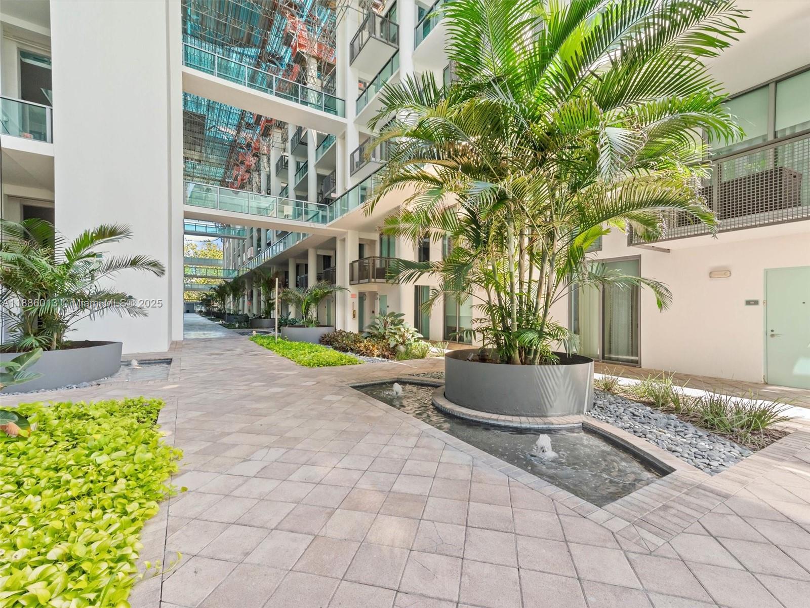 6000 Collins Avenue, Unit 132 Miami Beach, FL 33140 - Photo 18 of 24 a building outdoor space with lots of green space