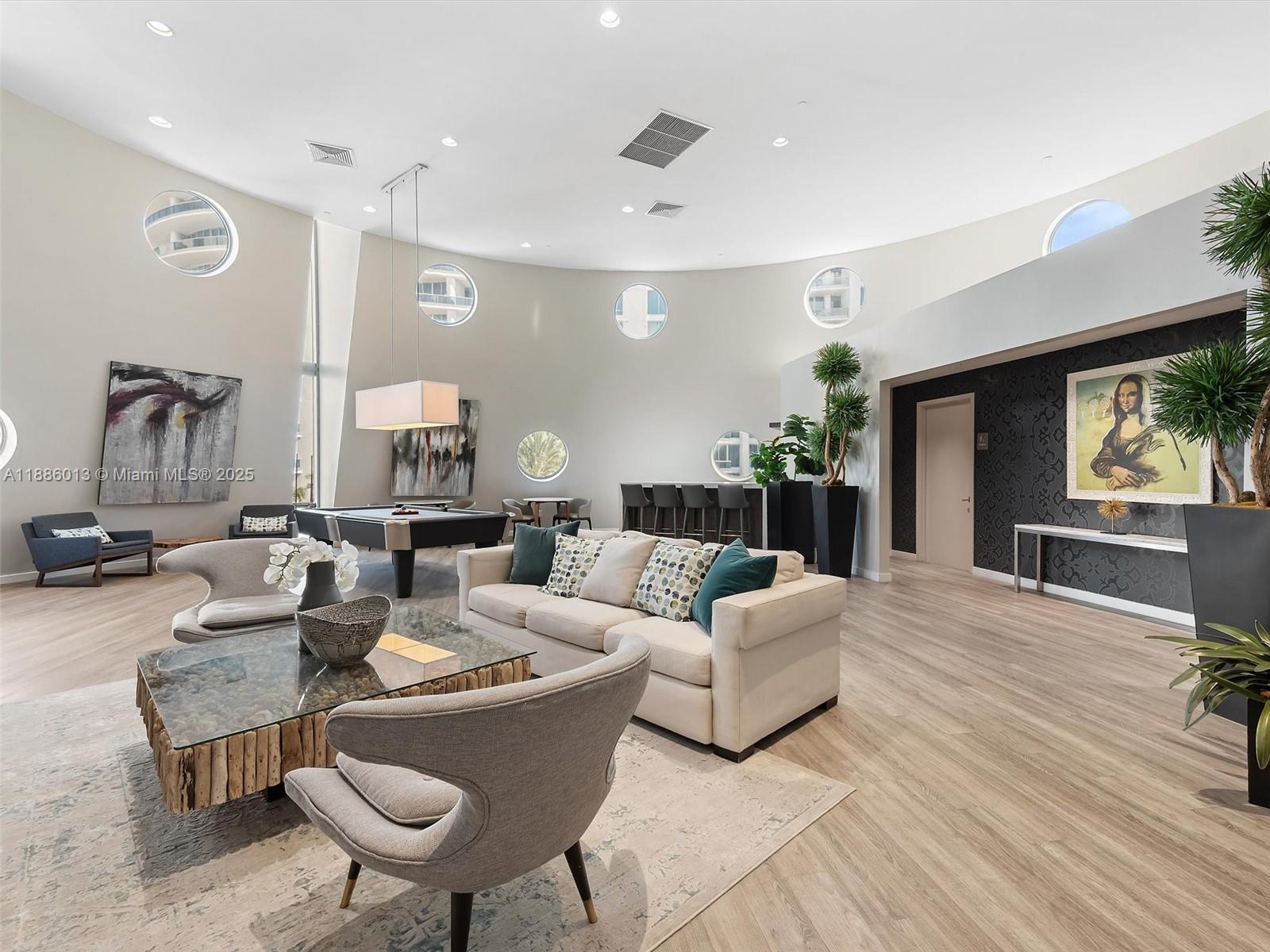 6000 Collins Avenue, Unit 132 Miami Beach, FL 33140 - Photo 20 of 24 a living room with furniture and a large window