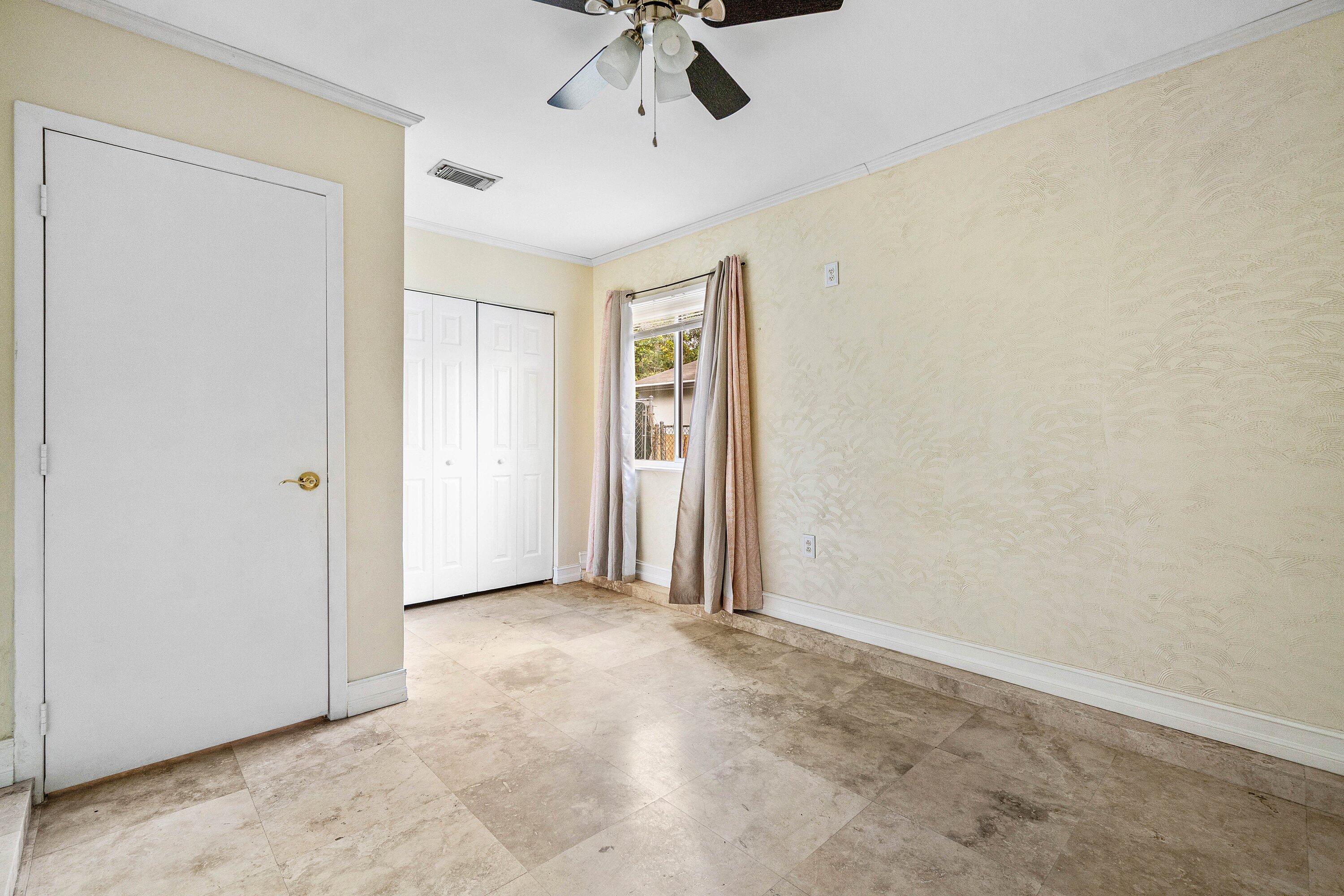 8411 Garden Gate Place Boca Raton, FL 33433 - Photo 10 of 12 an empty room with a ceiling fan and carpet