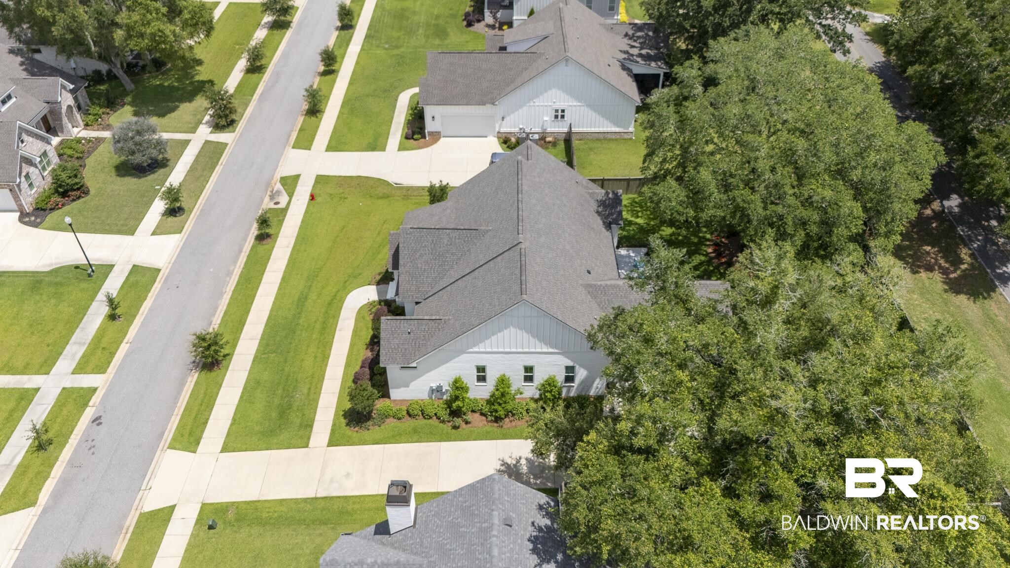 21702 Pillars Street Fairhope, AL 36532 - Photo 44 of 54 White board and batten exterior with a dark shingle roof